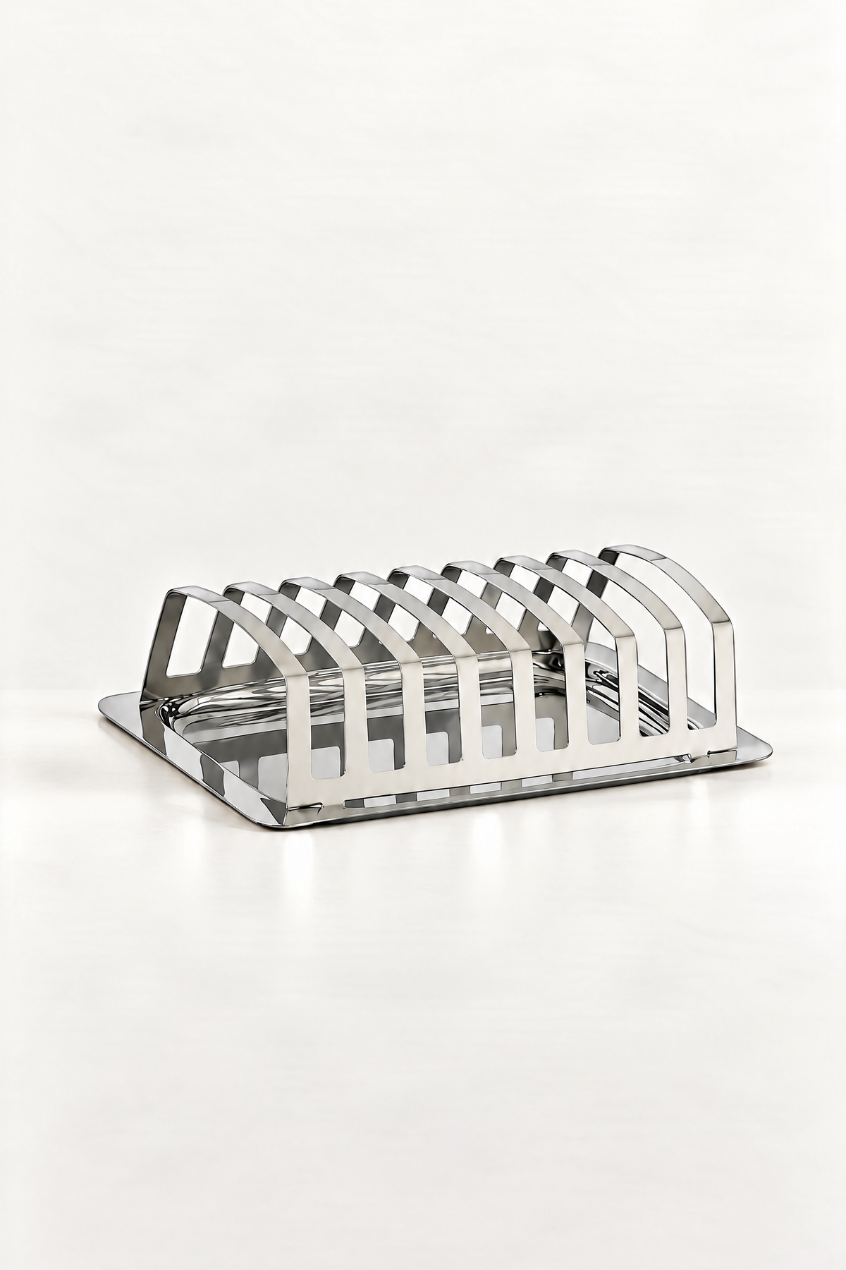A polished silver metal multi-slice bread toaster rack on a clean white background.
